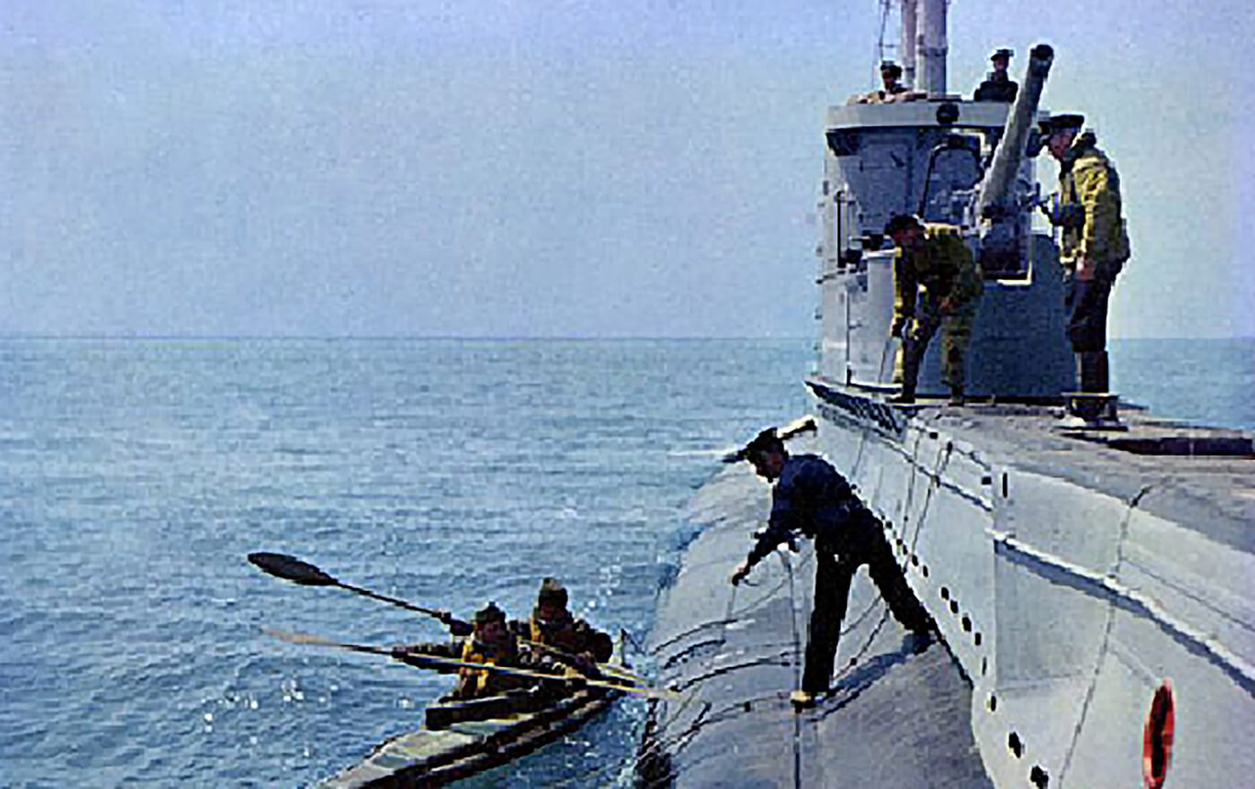 Cockleshell canoe with two operators being launched from a British submarine.