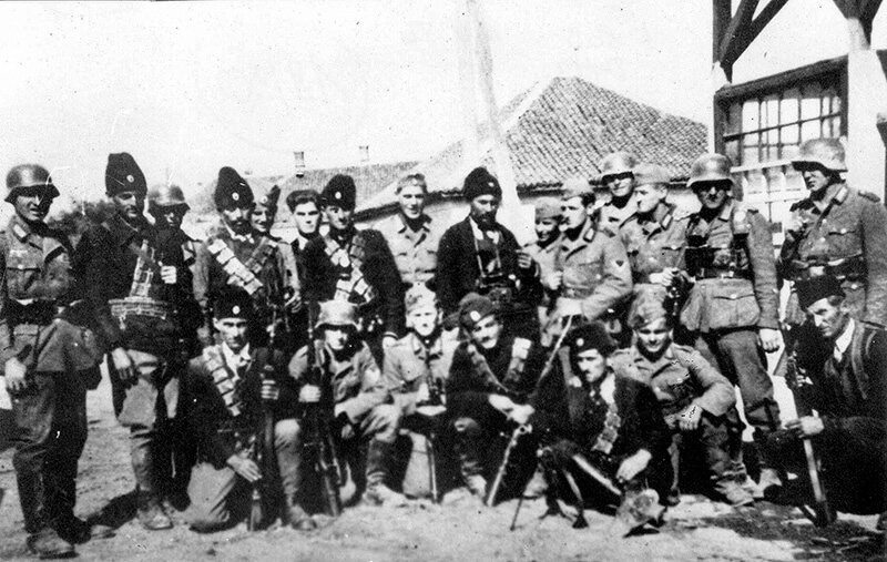 Chetnik posing with German Soldiers in the Soviet Union.