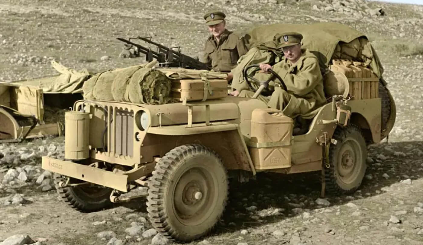 Two members of 1 SAS , Captain D C Mather MC, Welsh Guards and Captain G Alston, Royal Artillery (nearest camera) in a heavily loaded jeep.