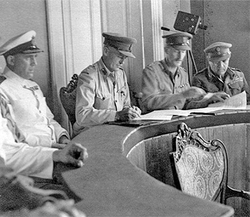 The signing of the German surrender at the Dodecanese by Brigadier Moffat and  Colonel Tsigantes (at the far right) 