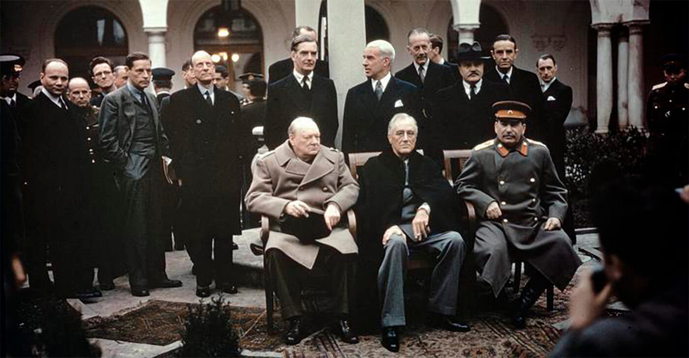 The Yalta Conference, Crimea, February 1945 The Prime Minister, the Rt Hon Winston Churchill, MP the President of the United States, Mr Franklin Roosevelt Marshal Joseph Stalin of the Soviet Union photographed in the grounds of the Livadia Palace, Yalta during the eight day Yalta Conference. Standing behind the three leaders are, left to right: the British Foreign Secretary, the Rt Hon Anthony Eden, MP the American Secretary of State, Mr Edward Stettinius the British Permanent Under-Secretary of State for Foreign Affairs, the Rt Hon Sir Alexander Cadogan the Soviet Commissar for Foreign Affairs, Mr Vyacheslav Molotov the American Ambassador in Moscow, Mr Averell Harriman
