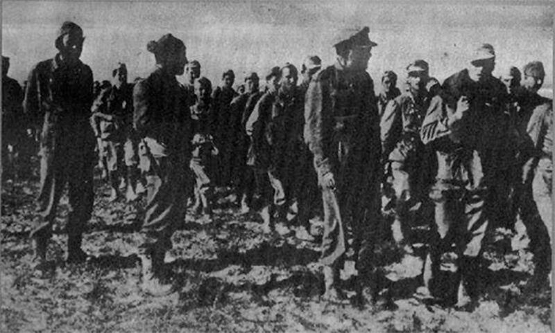 Colonel Tsigantes inspects German prisoners after the battle at Wadi Akarit.