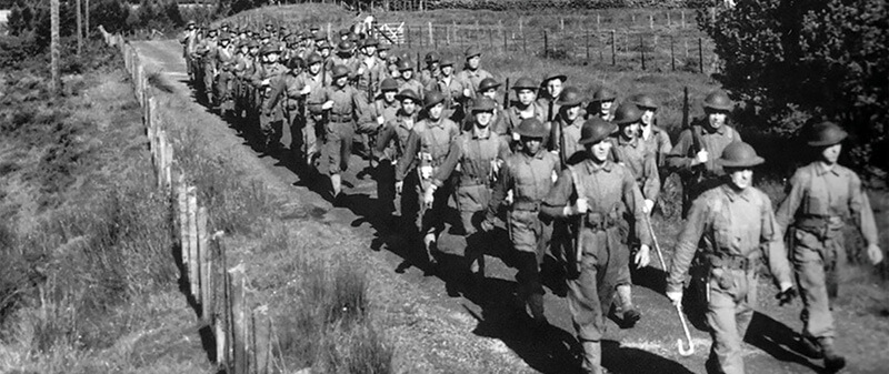 1st Lieutenant Alfred Nelson leads B Company, 1st Ranger Battalion on a training road march near Achnacarry, Scotland, July 1942