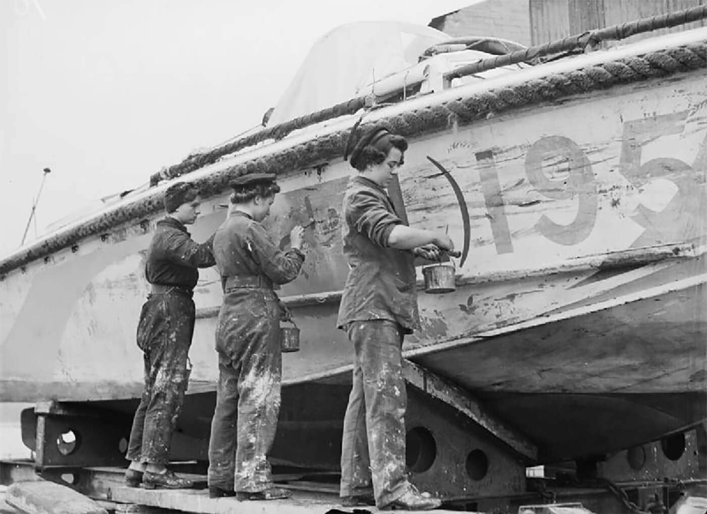 WRNS craftswomen painting a landingcraft (LCPL 195) at H.M.S. Tormentor, Southampton