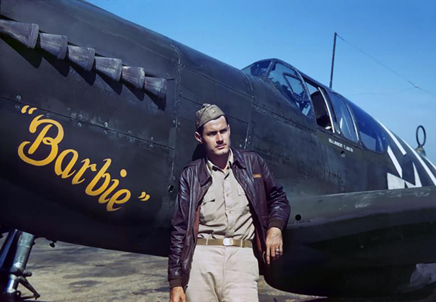 Colonel Robert “R.T.” Smith, standing in front of his North American P-51A Mustang fighter oft he 1st Air Commando Group. Barbie was the name of “R.T.’s” wife, a former Ford model.