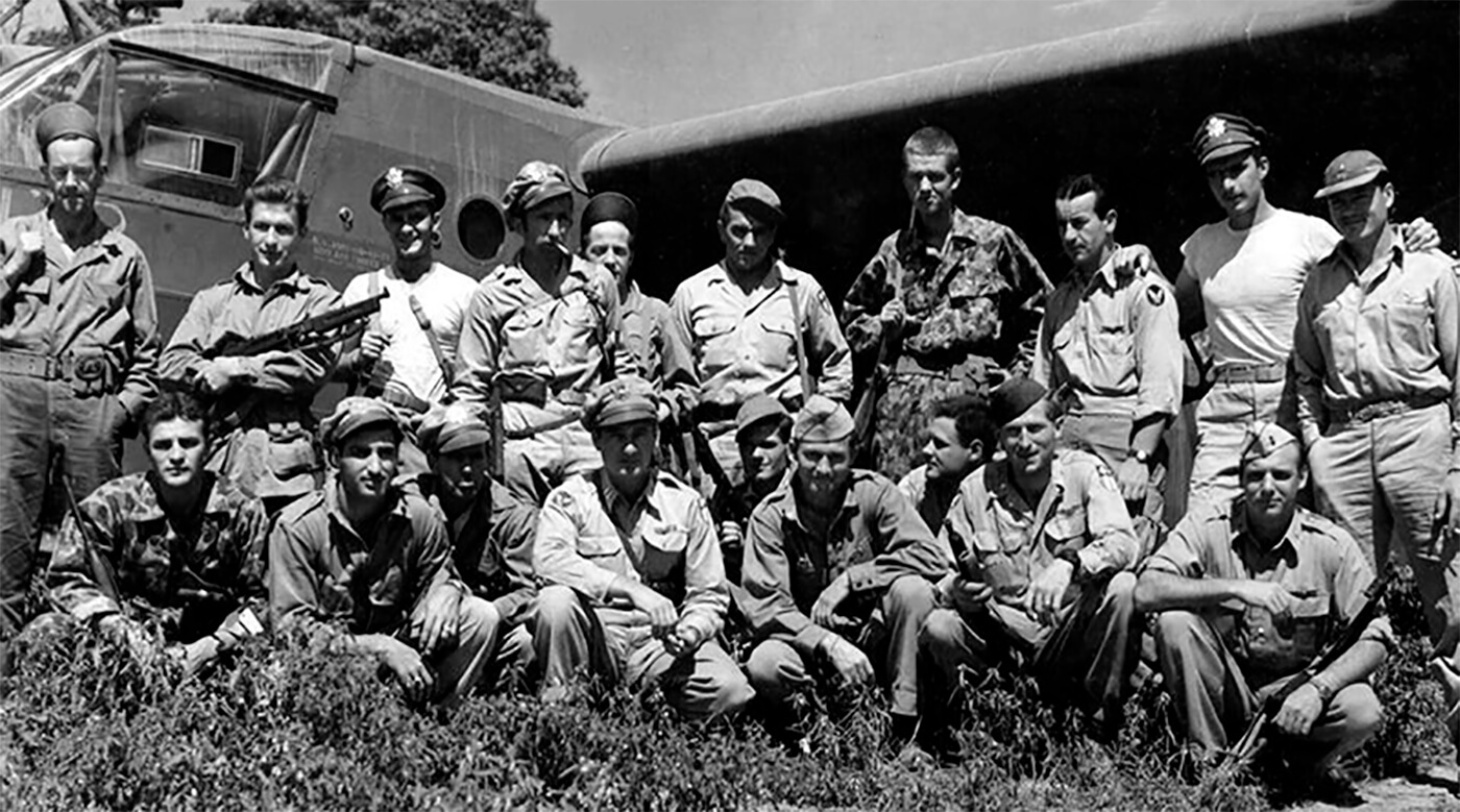 A group of Air Commando glider pilots with one of the 225 Waco CG-4 assault gliders that were assigned to the First Air Commando to carry “Chindit” formations deep behind Japanese lines. The pilot kneeling at the far right of the photo with the “Tommy” gun resting against his left arm, is the famous child motion picture star Jackie Coogan, who in the 1960’s would gain additional fame as “Uncle Fester” in the very popular television series “The Adams Family.”
