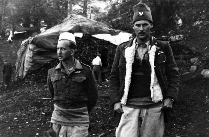 SERVICE OF MAJOR DAVID SMILEY WITH SPECIAL OPERATIONS EXECUTIVE (SOE) IN ALBANIA, 1943 -    1944. (HU 65071) First mission: Capt David Smiley and Maj Billy McLean at Bixha, October 1943. Note the    camouflaged HQ building in the background. Copyright: ý IWM. Original Source: http://www.iwm.org.uk/collections/item/object/205061273