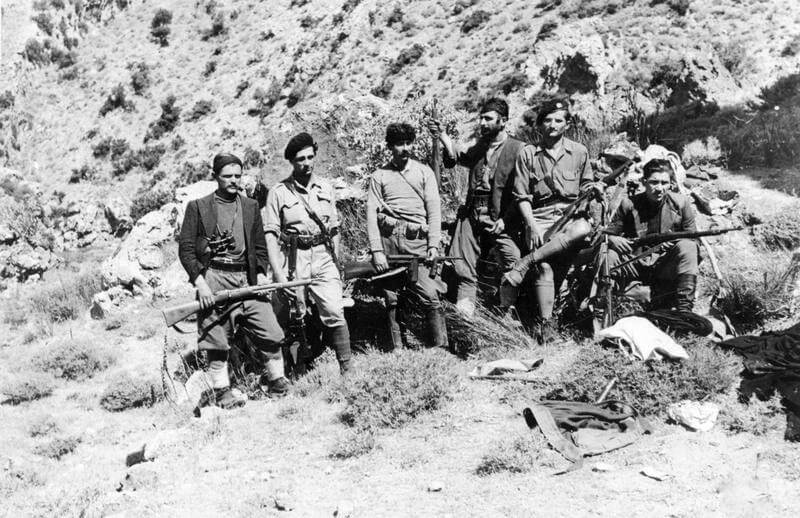 SOE (SPECIAL OPERATIONS EXECUTIVE) AND CRETAN PARTISANS ON CRETE, 1 JUNE 1944 - 28    FEBRUARY 1945. (HU 66069) A group of partisans, including Manolis Paterakis (second from right) pose for the camera. Copyright: ý IWM. Original Source: http://www.iwm.org.uk/collections/item/object/205045459