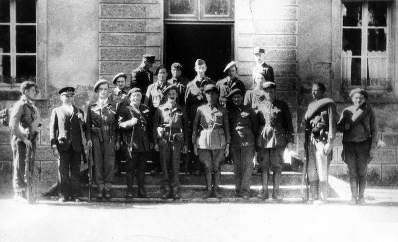 SERVICE OF KENNETH MACKENZIE WITH THE SPECIAL OPERATIONS EXECUTIVE (SOE) IN LUZY, FRANCE, SEPTEMBER 1944 (HU 68066) Group photograph taken on Liberation day at Luzy, 10 September 1944.  Front row (left to right):  Stationmaster Pinet, Captain Andre, Commandant Fradet, Kenneth Mackenzie, Captain Coffer (i/c gendarmes contingent from Le Creuset), Abbe Bonin of Maquis Preit, Lt Gendome. Copyright: ý IWM. Original Source: http://www.iwm.org.uk/collections/item/object/205046404