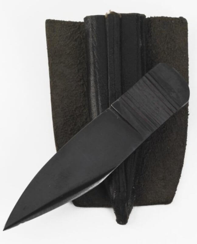 thumb knife with sheath (WEA 722) This small knife was developed during the Second World War for issue to agents of the British Special Operations Executive (SOE). It was known as the thumb knife, due to the method of holding it between thumb and fingers. An alternative name was 'lapel knife' as it was anticipated that the knife could be conveniently concealed by stitching its sheath to the underside of the lapels of the agent's c... Copyright: ý IWM. Original Source: http://www.iwm.org.uk/collections/item/object/30002920