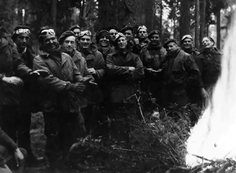 Some troopers of 2 Special Air Service gather around a campfire, warming their hands in the chill of the German spring night. They are preparing to cross the River Elbe.