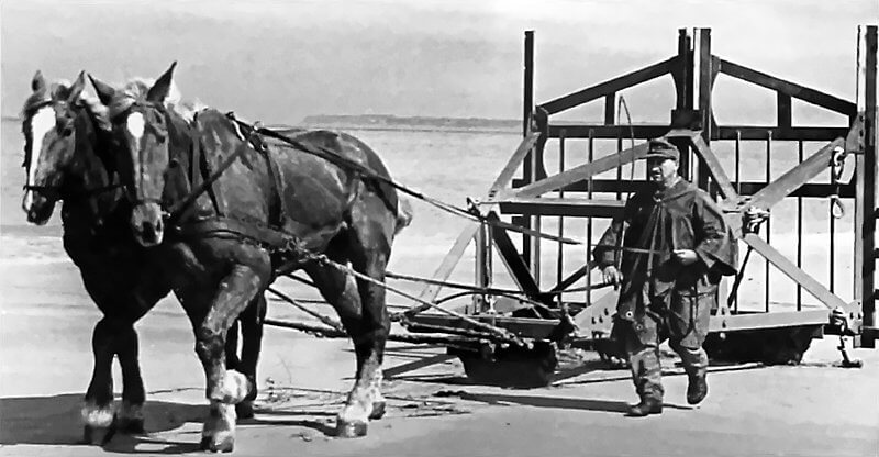 German soldier moving a Belgium Gate on the beach.
