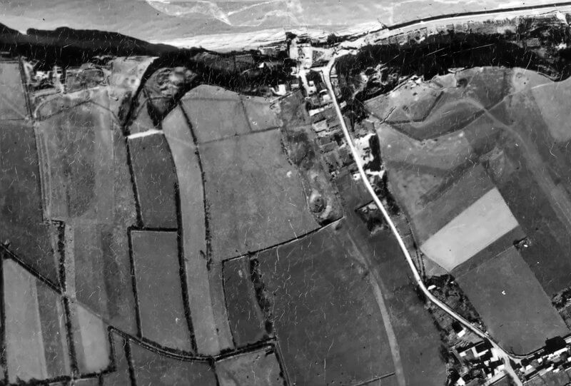 Old aerial photograph showing Widerstandsnest 71, 72, and 73, with the road and beach cutting leading to Vierville-sur-Mer.