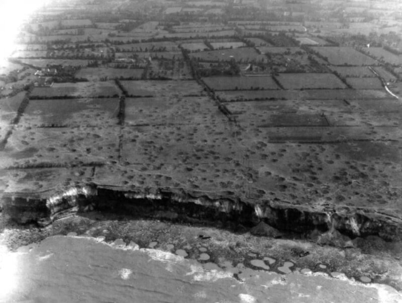 Pointe du Hoc landing beach with still two beached Landing Craft Assault on the it.