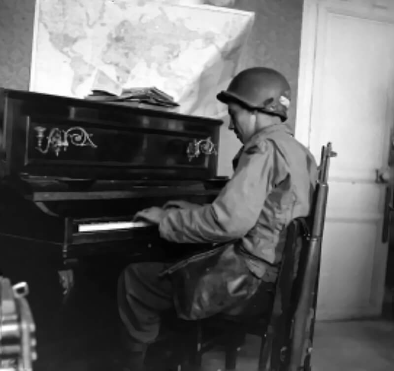A US Ranger plays the piano in Osmanville.