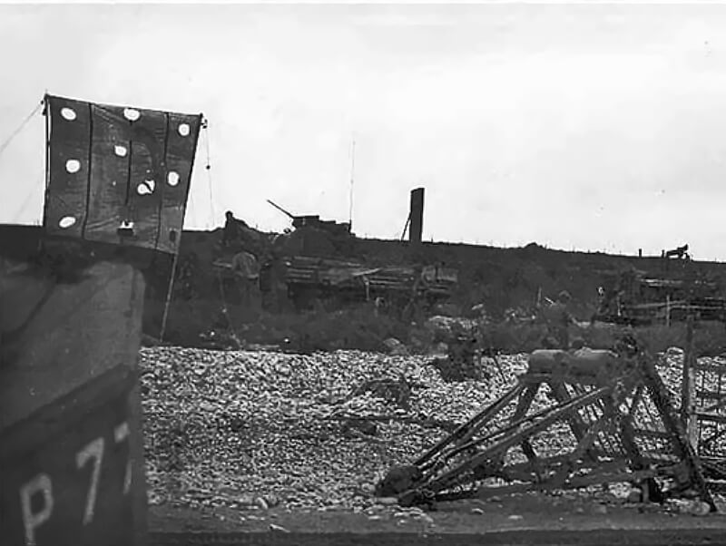 Surviving Sherman DD approaches WN61, fires into the R677 embrasure, possibly Staff Sergeant Sheppard’s tank disabling the 88-mm gun.