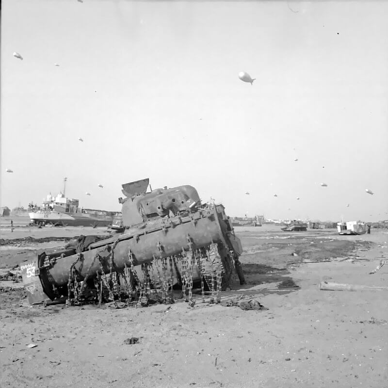 The British Army in the Normandy Campaign 1944 A Sherman Crab flail tank of the Westminster Dragoons, 79th Armoured Division, disabled on the beach, Gold area, June 7th, 1944.
