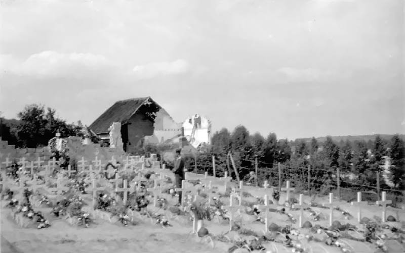 Graves of Belgian grenadiers near one of the houses damaged during the fighting.