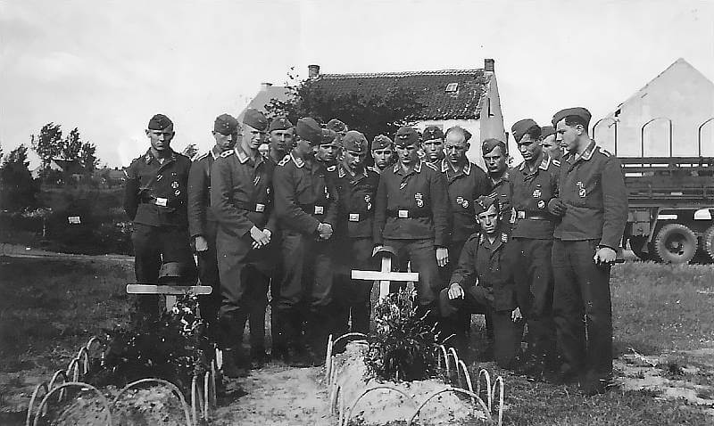 Members of Assault Group Granit pause to remember Max Maier, leader of Gruppe 2. The Fallschirmjäger not wearing a cap is Walter Meier.