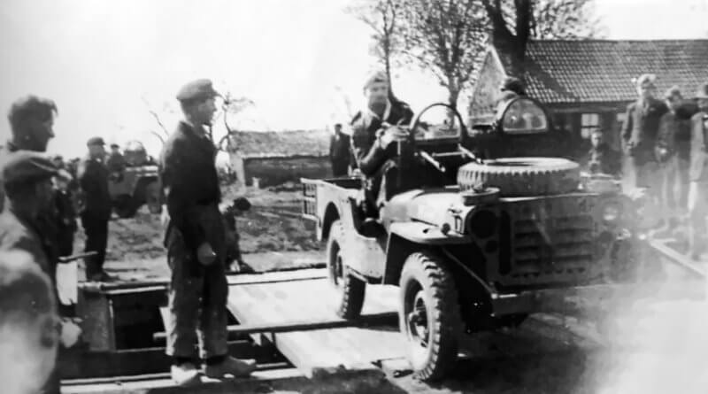 April 11th, 1945. Belgian and French SAS jeeps cross the emergency bridge at the lock gate on the Oranjekanaal, constructed with the help of the local population.