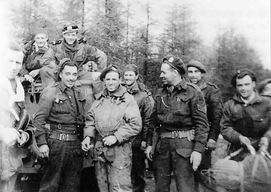 April 13th, 1945, Bois de Gieten. Men of Stick Legrand board Bren carriers for the return to Rolde. Their German officer prisoners have evidently lost their caps.