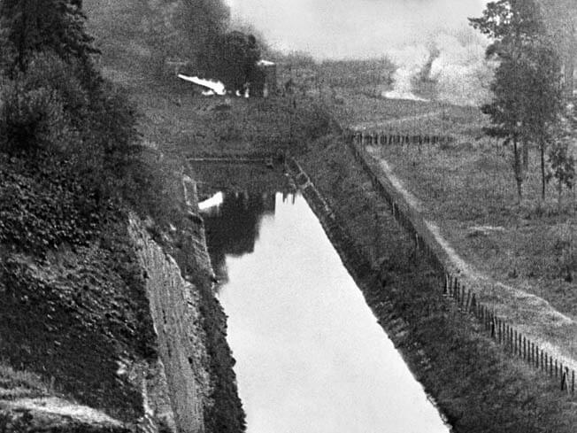 May 11th, 1940. German assault troops after crossing the Albert Canal, with a flame-thrower attack on a Belgian position visible upper left.