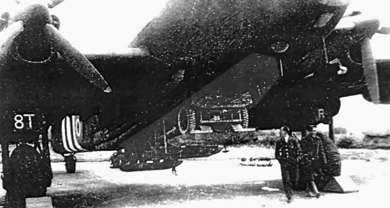 The jeep is suspended beneath the aircraft’s fuselage, with the bomb aimer operating the release mechanism used for supply containers.