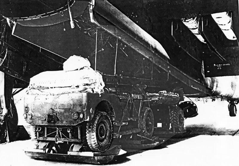 The bomb bay doors of Halifax Mk III and Mk V bombers, and some Short Stirlings, are removed to accommodate parachute-equipped jeeps.